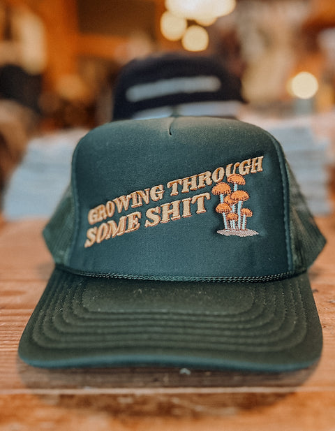 GROWING THROUGH SOME SH*T trucker hat