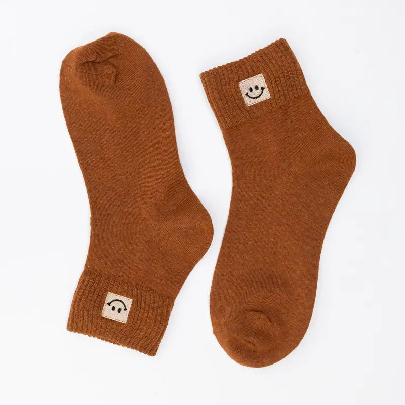SNOWED IN smiley-face socks